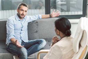 a man talks to a counselor during dual diagnosis treatment in Joliet